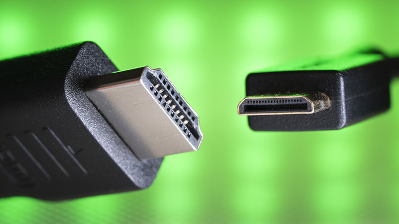 Mini HDMI cable connectors against a green background