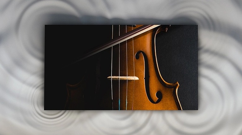 Samsung's 114-inch Micro LED MS1C TV mounted to a wall with an illustration of sound waves in the background