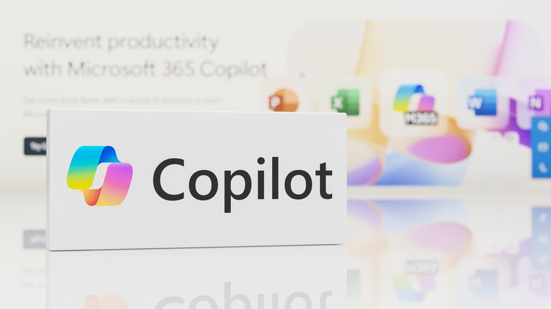 A sign with a Copilot logo on it sitting on a table in front of a Microsoft 365 banner