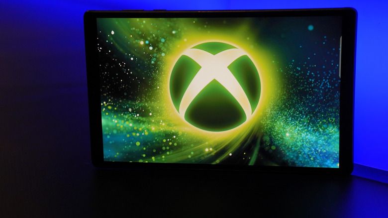 xbox logo on a TV / tablet screen, dark room
