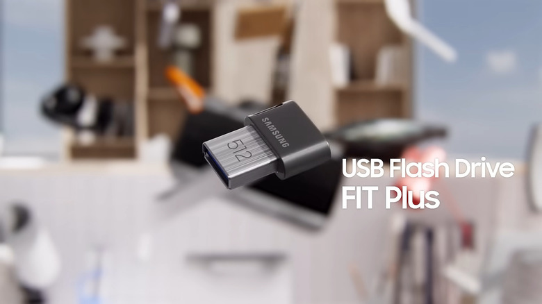 Samsung's USB Flash Drive FIT Plus floating above a computer.