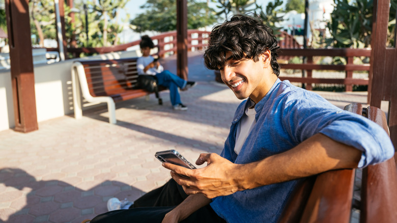 Young man using a smartphone while outside