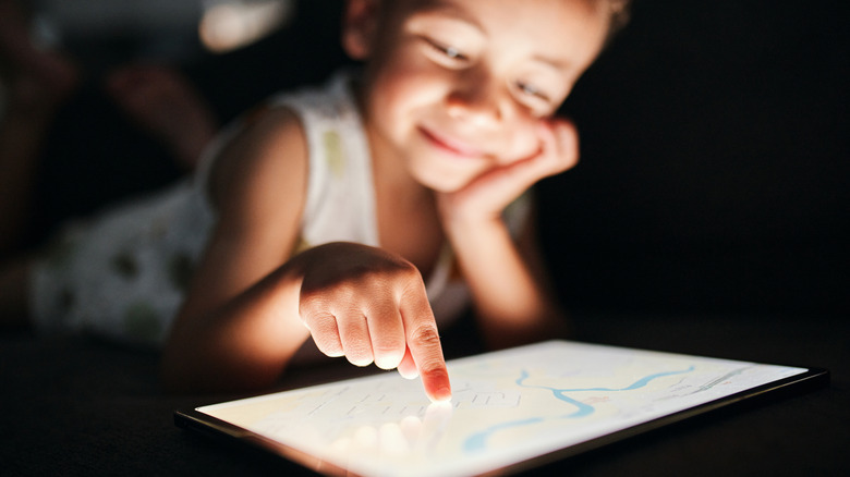 A child using a touchscreen tablet