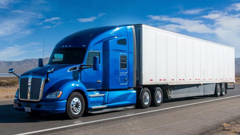 A semi truck driving down the highway