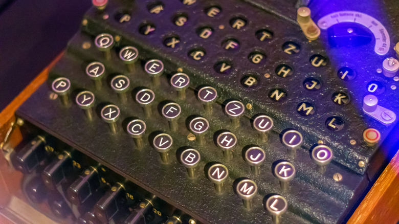 Close-up of a vintage cipher machine with round, typewriter-style keys arranged in a grid.