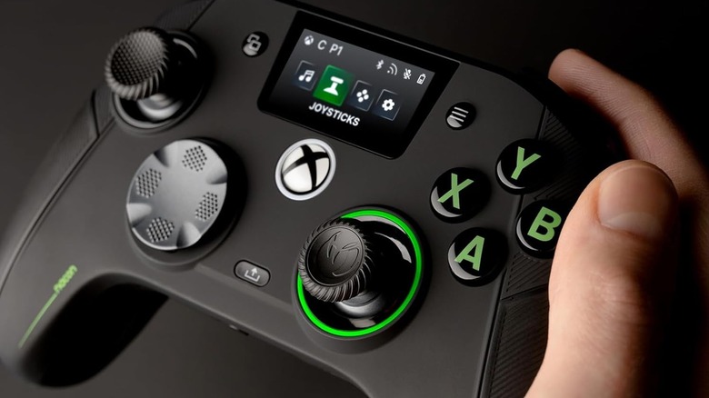 Nacon Revolution X being held in the right hand demonstrating the on-device config screen