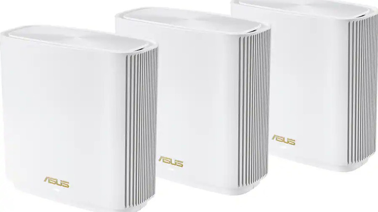 Three Asus ZenWiFi AXE7800 mesh routers in white with a clean, minimalist design.