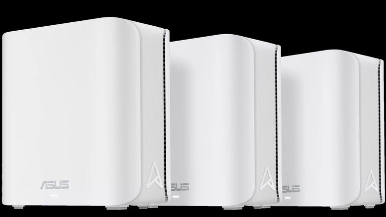 Three Asus ZenWiFi BD5 mesh routers in white, shown side by side against a dark background.