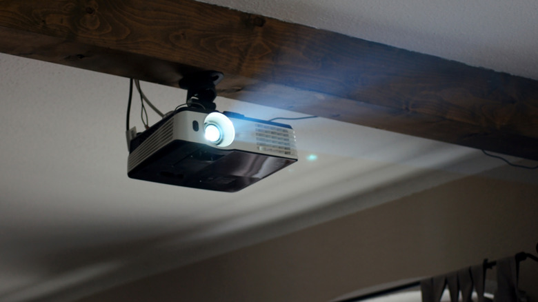 A home projector mounted on a ceiling.