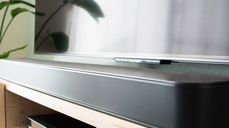 A soundbar in front of a TV.