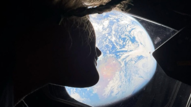 Crew member of the Artemis 2 mission with the Earth on the background