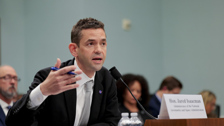 Jared Isaacman, dressed in black suit, white shirt, and grey tie, testifies before Congress during a 2026 Senate appropriations committee hearing