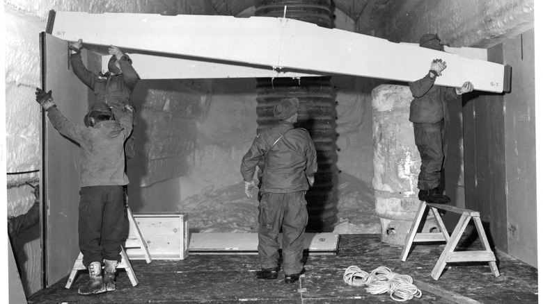 Men building supports inside Camp Century in Greenland.