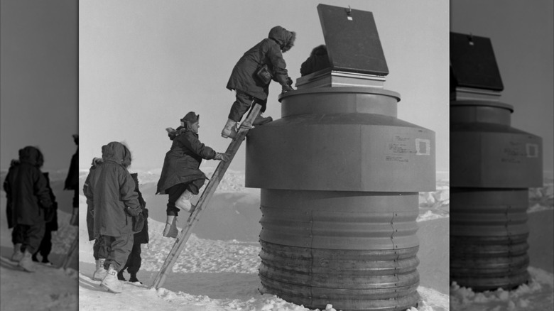 People climbing into Camp Century