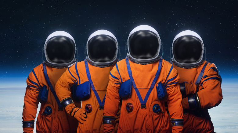 four astronauts in Artemis spacesuits
