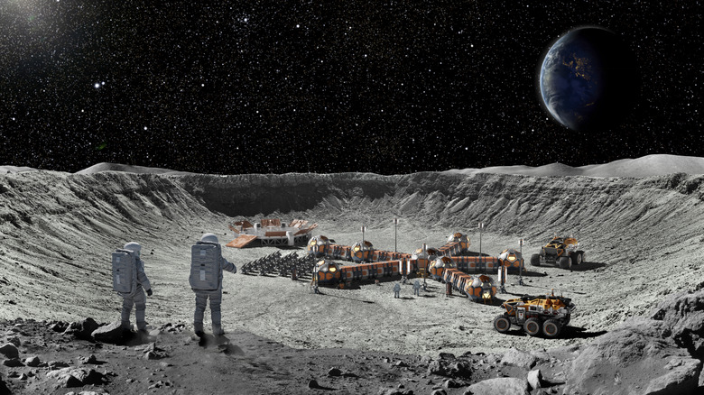 Conceptual image of two astronauts looking down at a lunar base in a crater