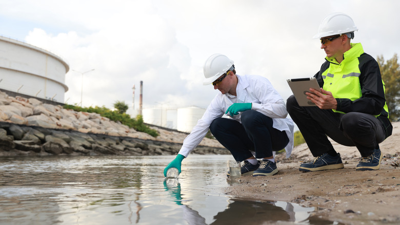 Scientists taking water samples from a river.