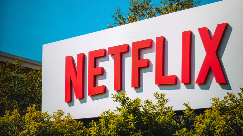 The Netflix logo outside of a corporate office in California, the logo is surrounded by trees