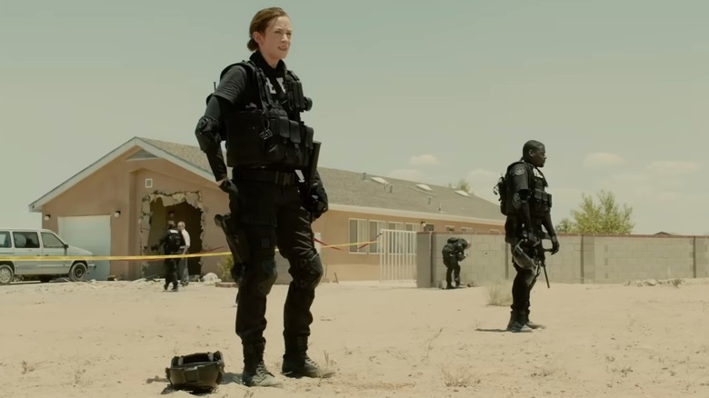 Kate Macer (Emily Blunt) standing outside in tactical gear in the movie Sicario