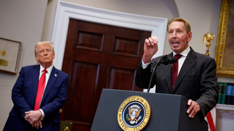 Larry Ellison, billionaire father of Paramount head David Ellison, speaks at the White House as President Donald Trump watches.