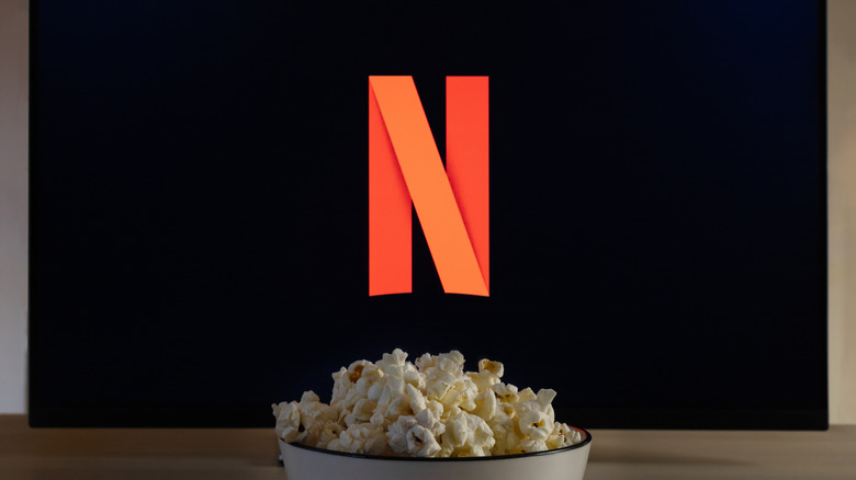 Netflix logo on a display with popcorn in the foreground.
