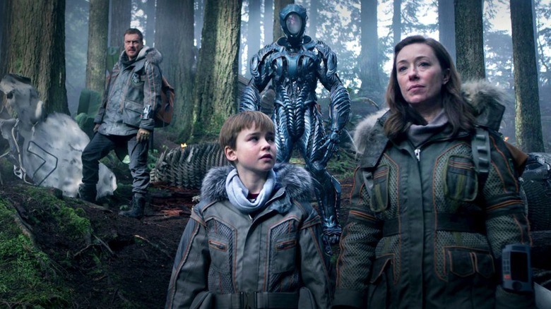 Three Robinson family members and the robot in Netflix's 