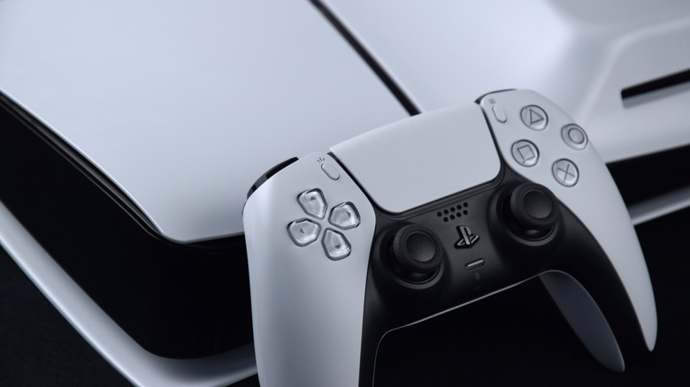 A close-up of a PlayStation 5 console and controller