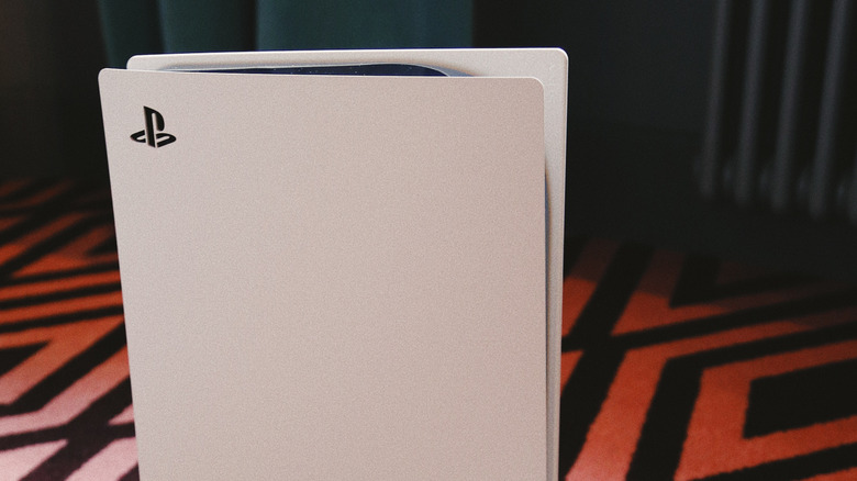 The top half of a PlayStation 5 sitting on a carpet