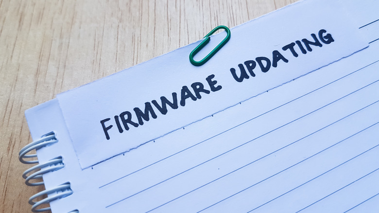 A notebook with handwritten text about a firmware update