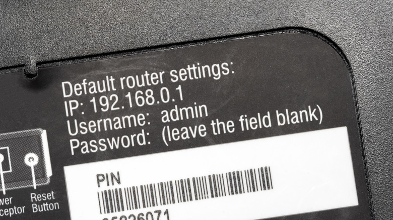 Default router settings and password sticker on the back of a router