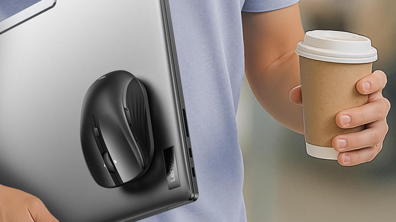 Man holding laptop with ESR MagMouse attached