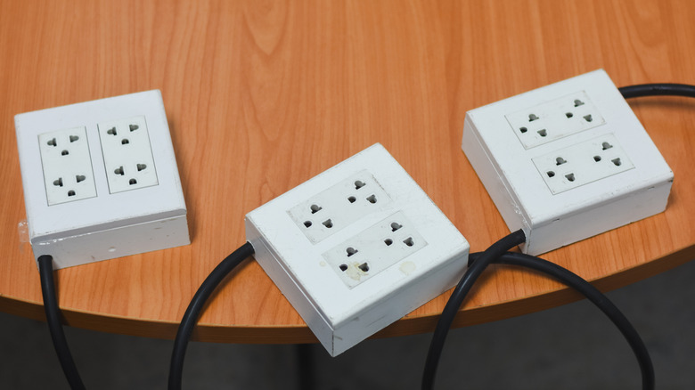 Three power strips placed on a table
