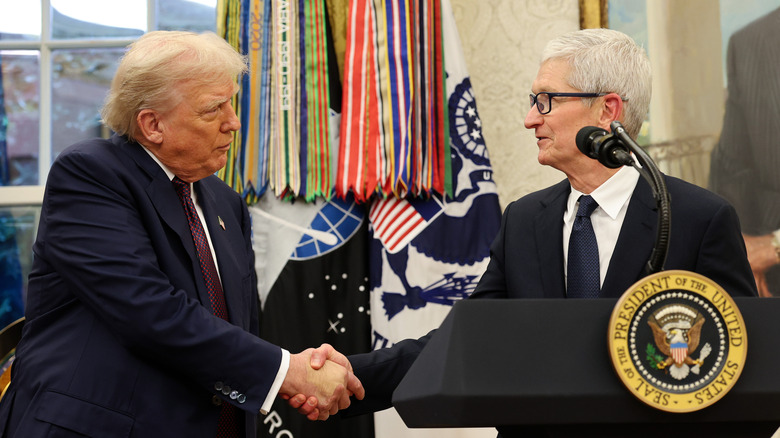Apple CEO Tim Cook shaking hands with U.S. President Donald Trump during an event at the Oval Office on August 6, 2025.