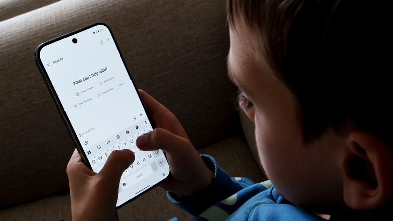 A child using ChatGPT on a smartphone.