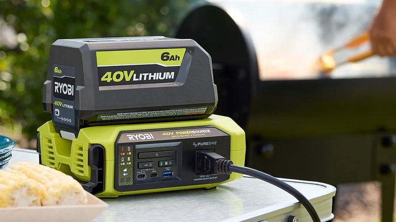 RYOBI 40V 300W Power Source & Charger sitting on top of table next to grill