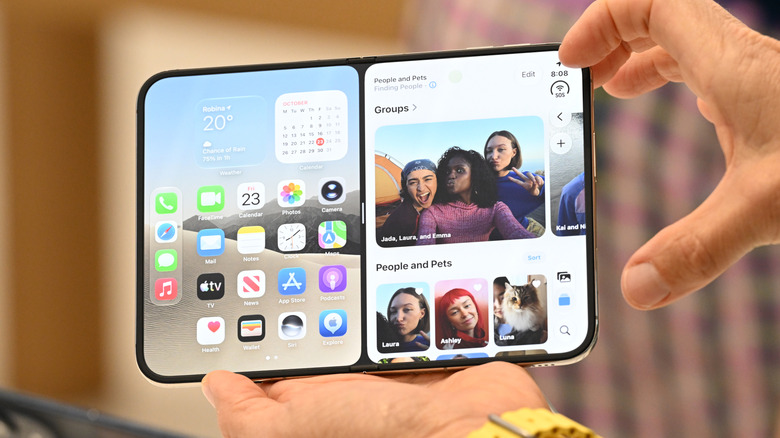 Apple Store staff showing iPhone Duo to customers