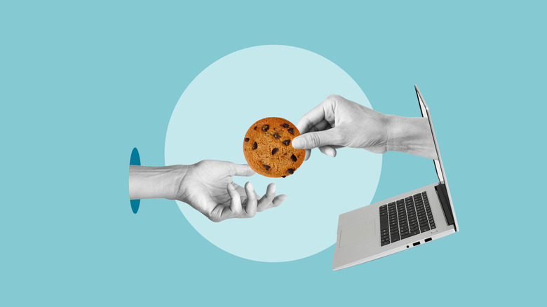 One person handing another a cookie with a laptop below showing cookie consent.