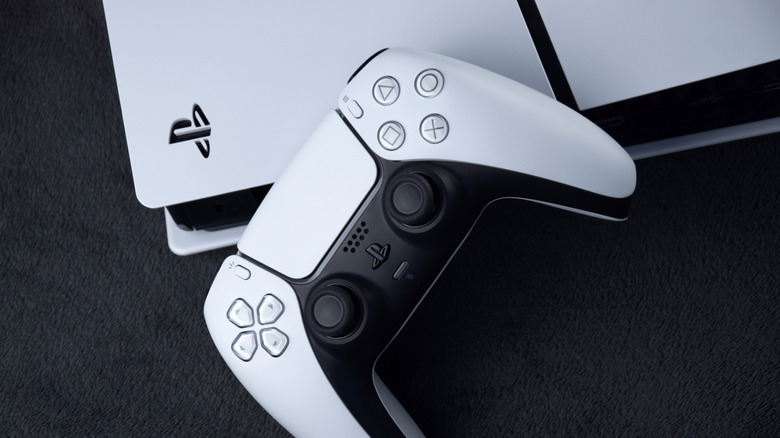 PlayStation 5 DualSense controller resting on top of PS5 console