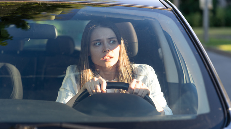 a scared woman in her car