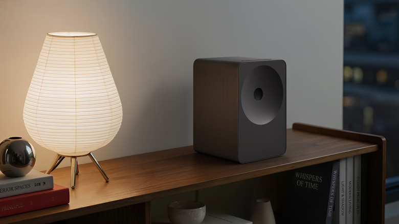 The Samsung Music Studio 7 wireless speaker placed on a bookshelf next to a lamp