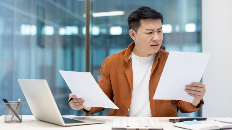 A reporter comparing details between sources