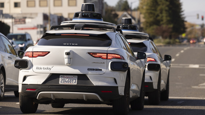 Waymo self-driving cars moving through traffic