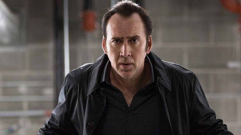 Noah (Nicolas Cage) standing in front of a wall in 