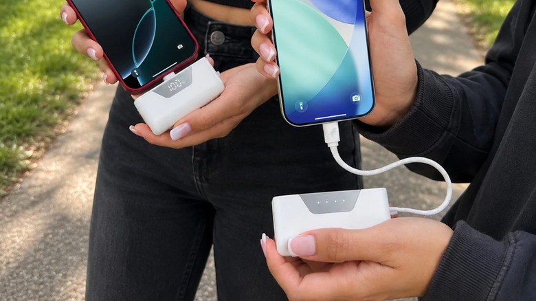 Two individuals share a Nimble Sharepower Portable Charger that has been split into two