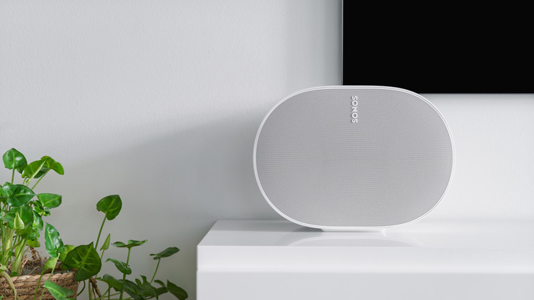 The Sonos Era 300 in white, placed on top of a TV stand