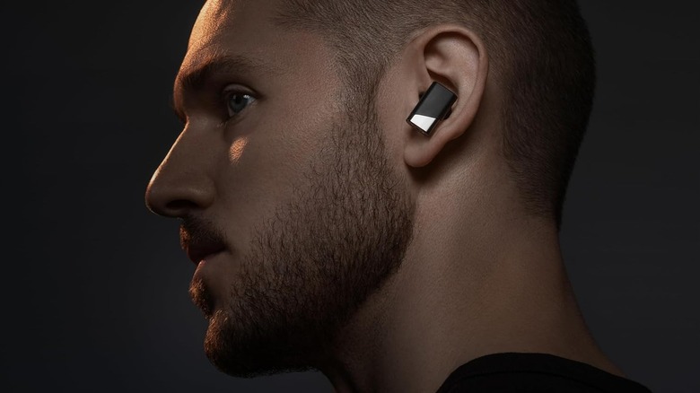 A man wearing the Status Audio Pro X wireless earbuds.