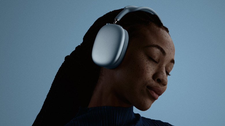 A woman using a pair of Apple AirPods Max 2