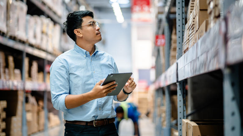 An employee checking inventory in a warehouse