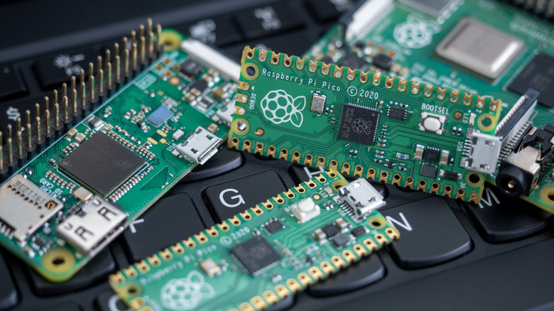 Various Raspberry Pi models placed on a laptop keyboard.