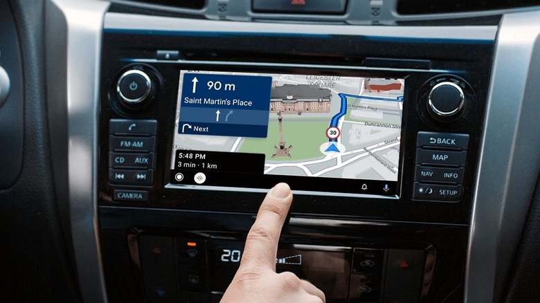 Close-up of a person interacting with Sygic GPS Navigation on Android Auto